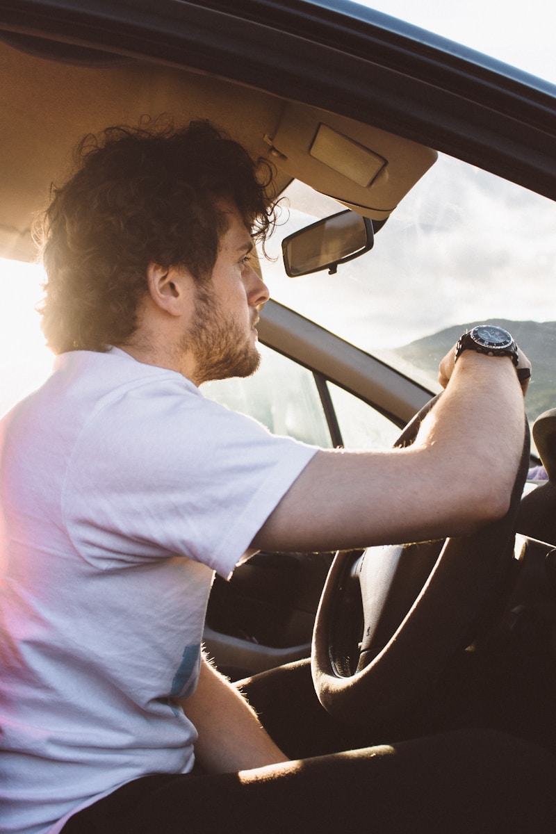 man holding steering wheel this is What Happens When Someone Else Drives Your Car and Gets in an Accident