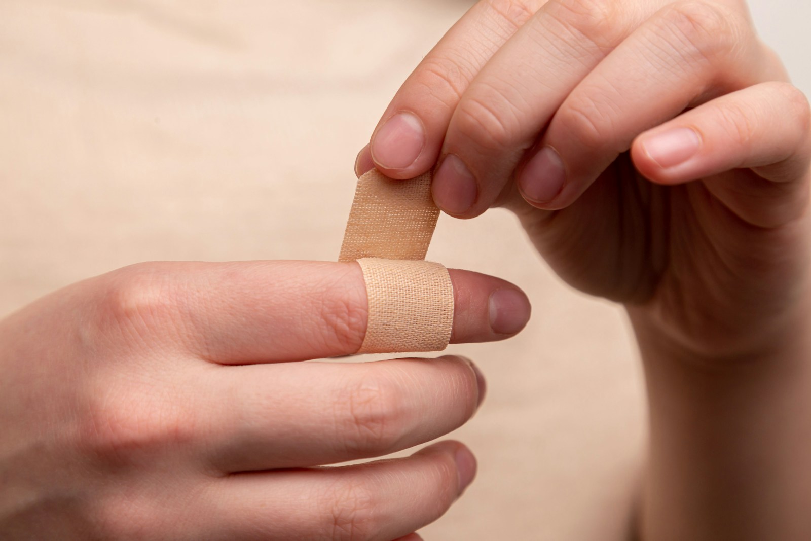 person with band aid on middle finger because they have general liability insurance